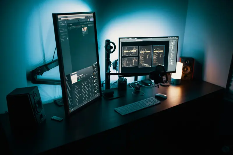 Developer workstation with two monitors in a dark studio